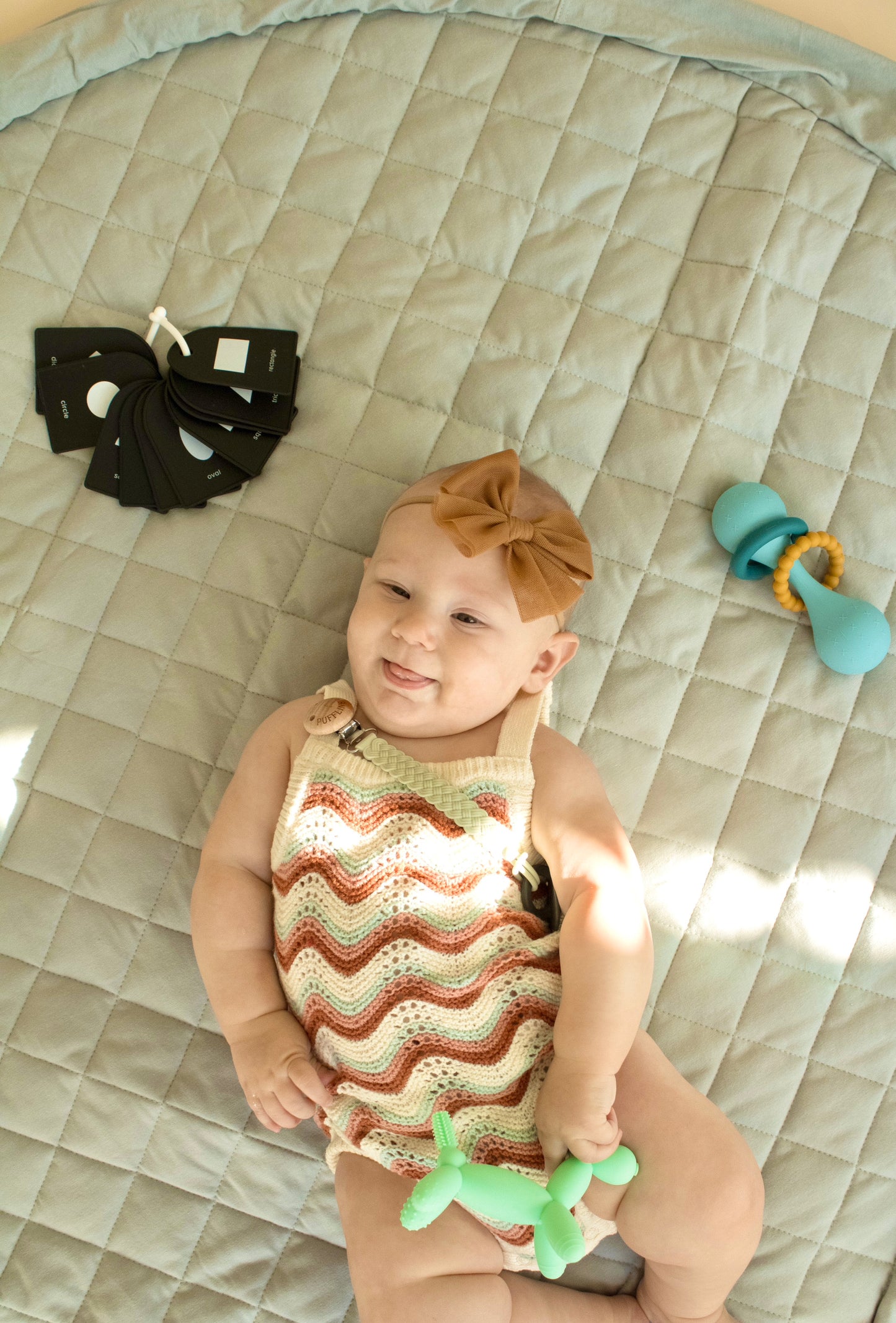 Puffling The Nomad Play Mat Storage Bag, cotton play mat, diaper bag, toy storage bag, baby play mat, laid down with baby on it