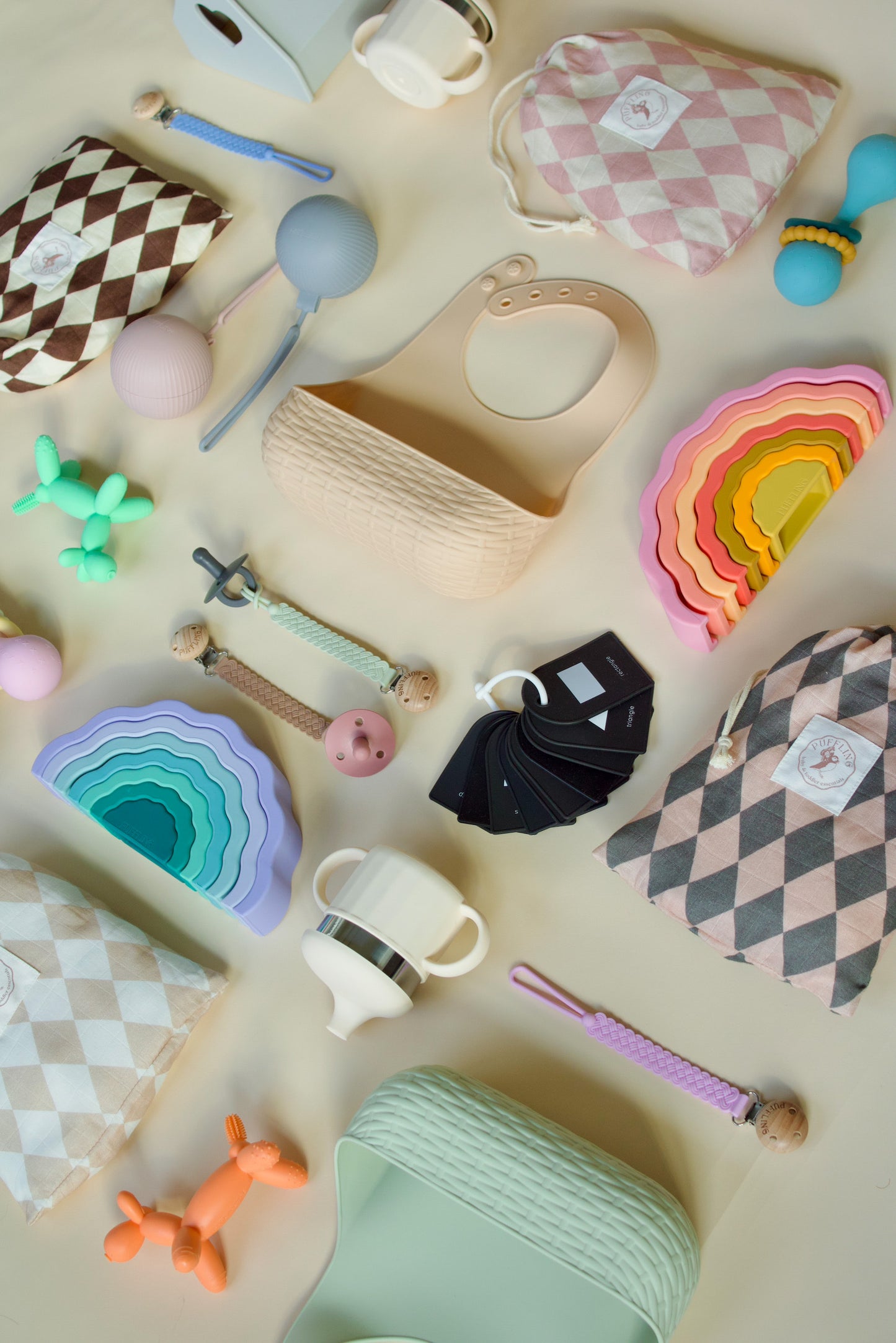 Puffling Party Animal Teether, Clementine Orange Color, nontoxic baby teether, teething toy, silicone, mushie, mushie teether, view with puffling products laid out