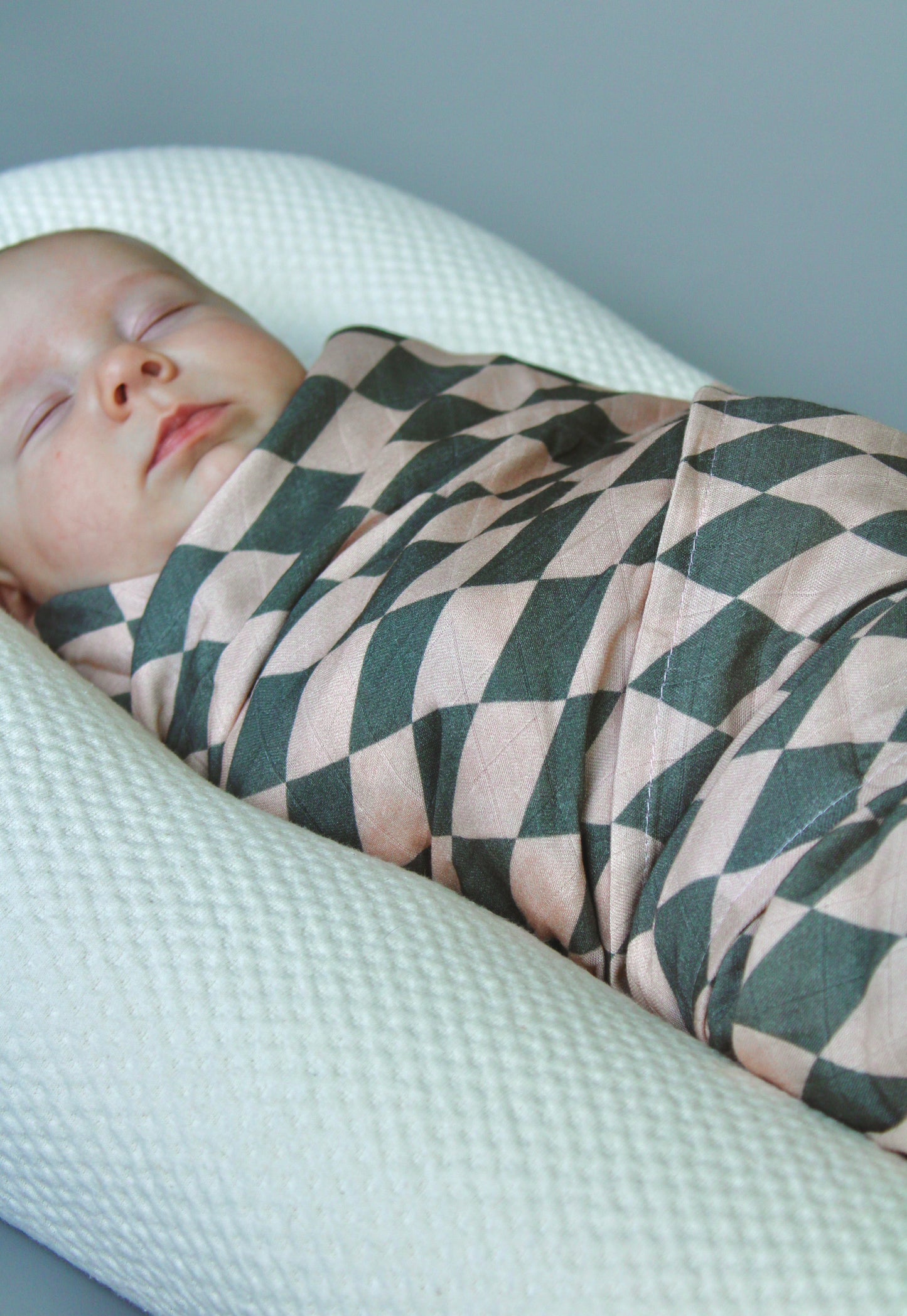 Puffling Supremely-Soft Swaddle, Organic bamboo and muslin cotton, baby swaddle blanket, checkered pattern, checkerboard blanket, diamond pattern, soft baby blanket, neutral baby blanket, sleeping baby view
