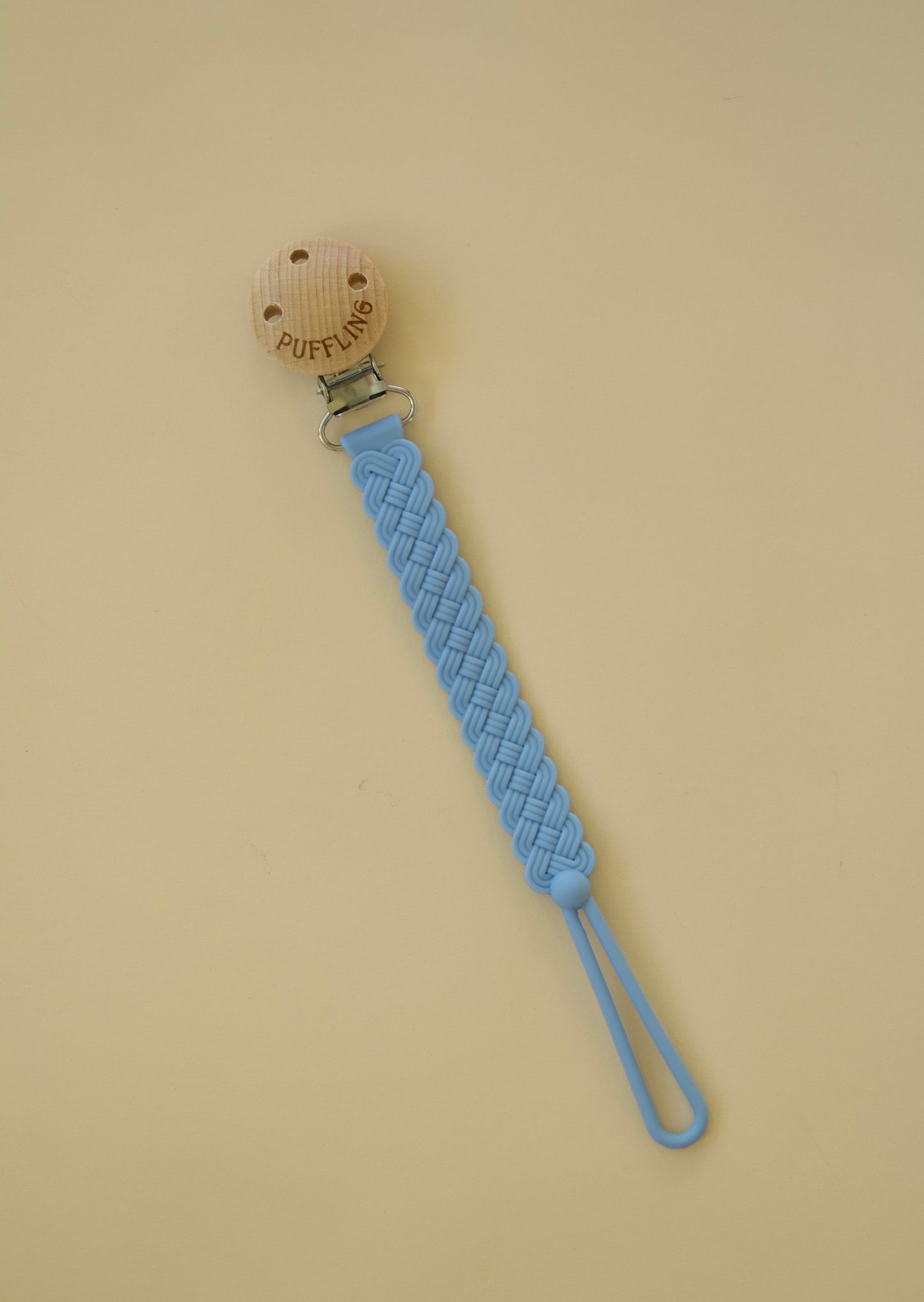 Puffling Woven Anti-drop Pacifier Clip, mushie pacifier clip, dummy clip, binky clip, silicone pacifier clip, blue cerulean color, cerulean blue diagonal lay