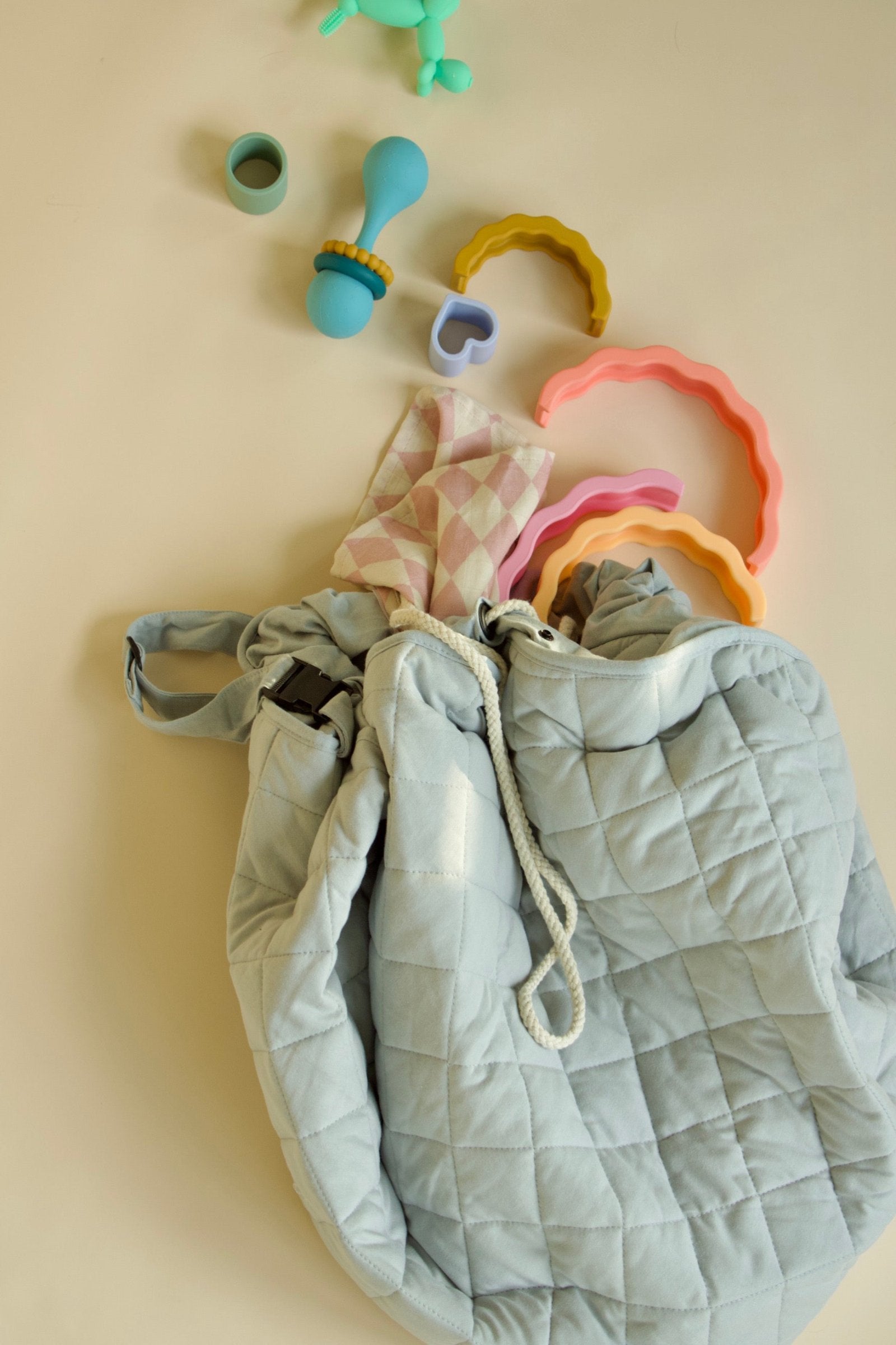 Puffling The Nomad Play Mat Storage Bag, cotton play mat, diaper bag, toy storage bag, baby play mat, laid down with toys coming out