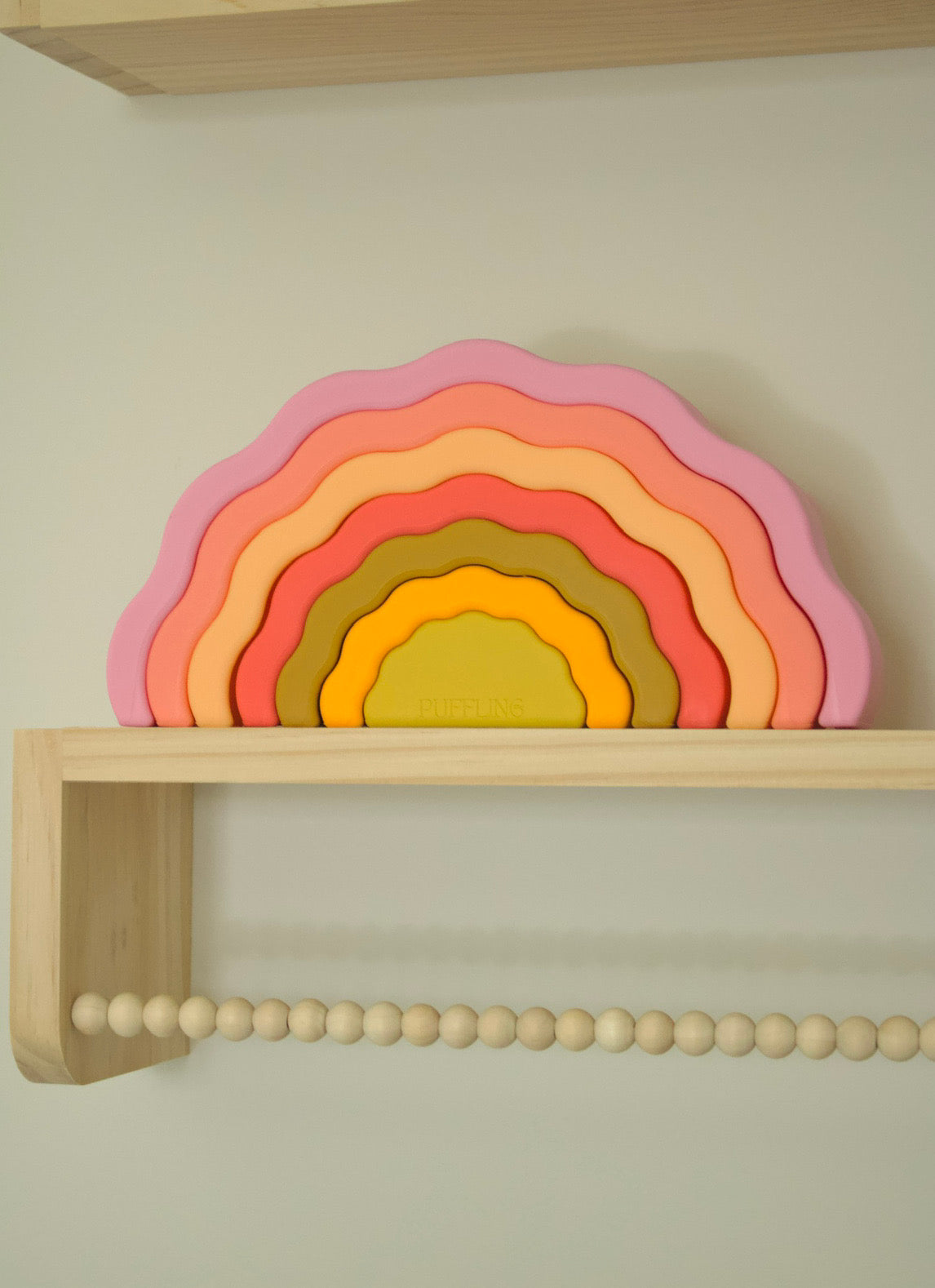 Puffling the Sunset Stacker, rainbow stacker toy, rainbow stacking toy, developmental toy, silicone toddler baby toy, nontoxic toy, wavy rainbow toy, cotton candy pink color, mushie toy, baby nursery decor view